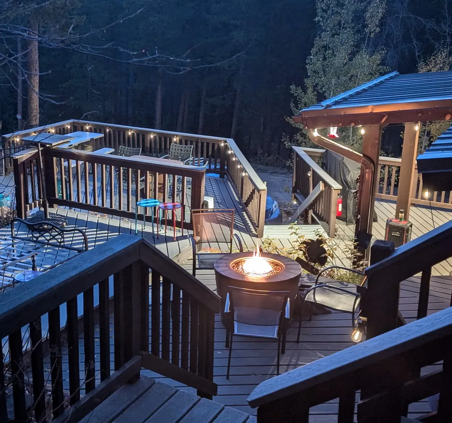 Gathered around the glowing firepit on the deck after dark.