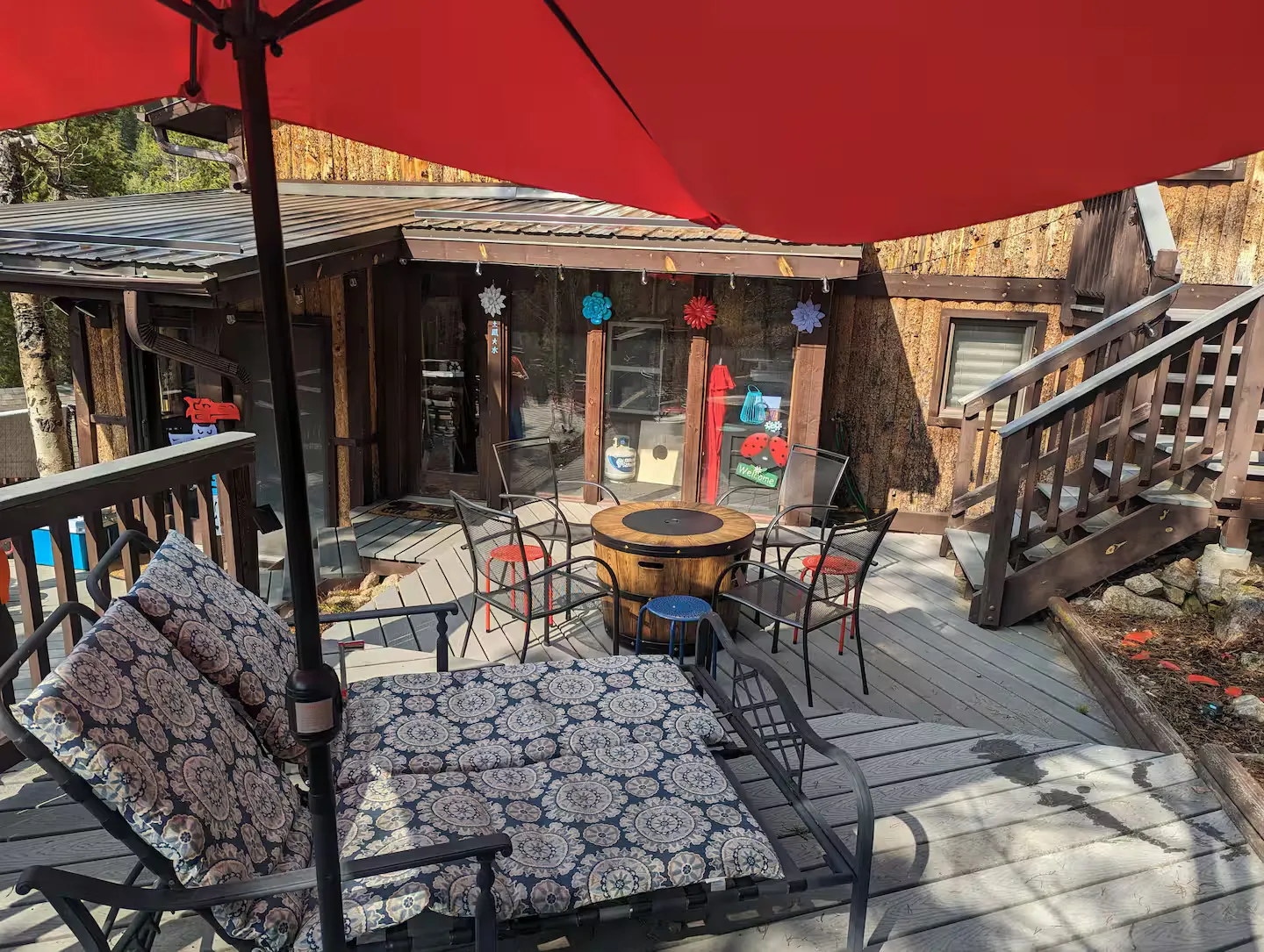 Shaded seating under an umbrella on the deck.