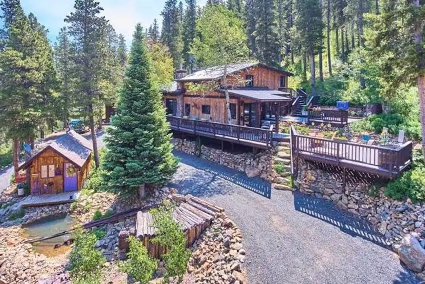 Aerial view of Rivendell Cabin and its driveway tucked into four forested acres.