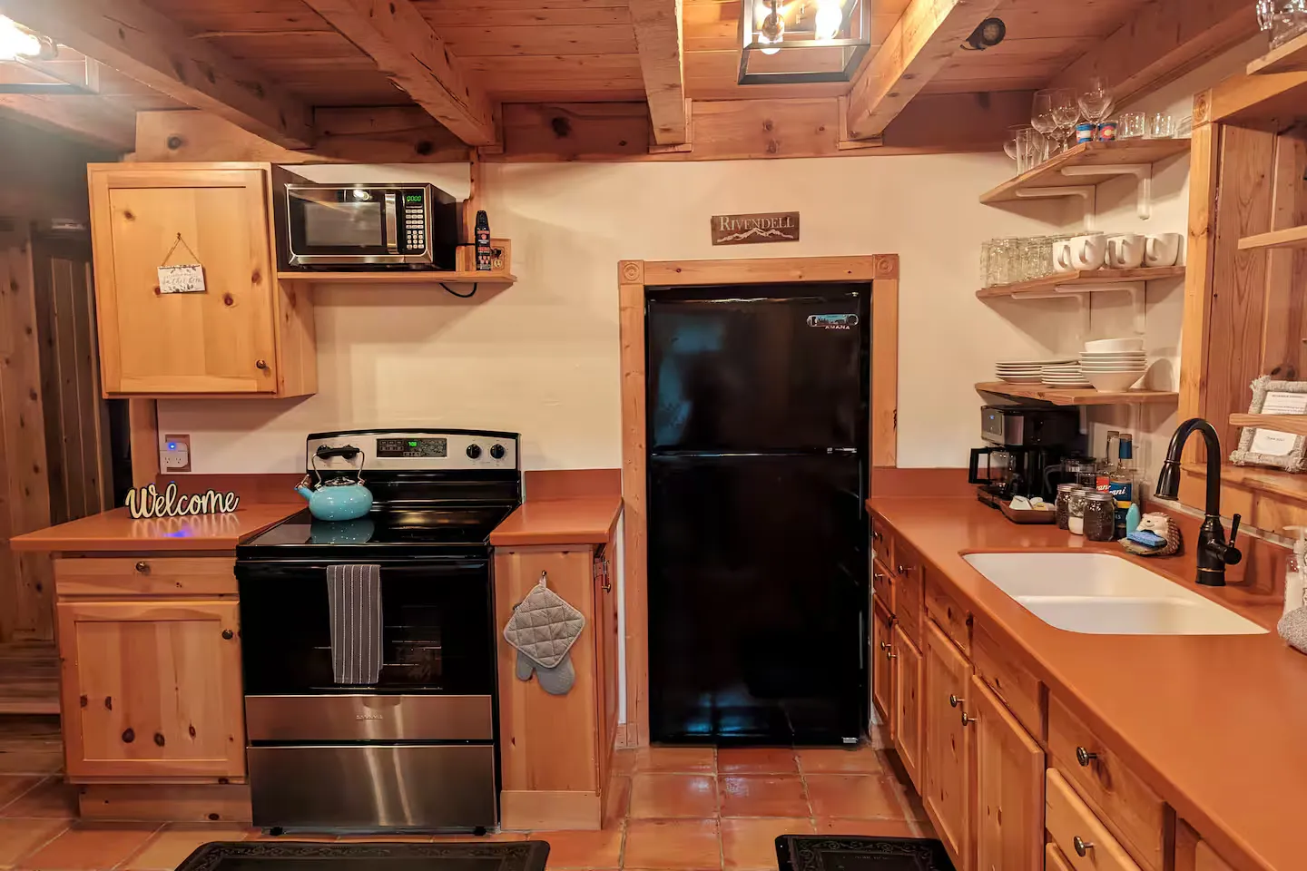 The kitchen with full-size refrigerator and ample storage.