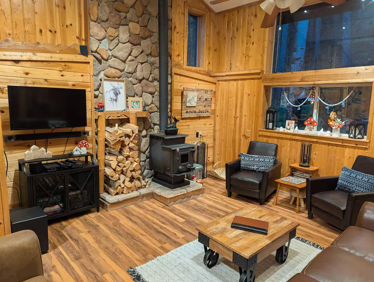 The open living room with vaulted ceilings and large windows.