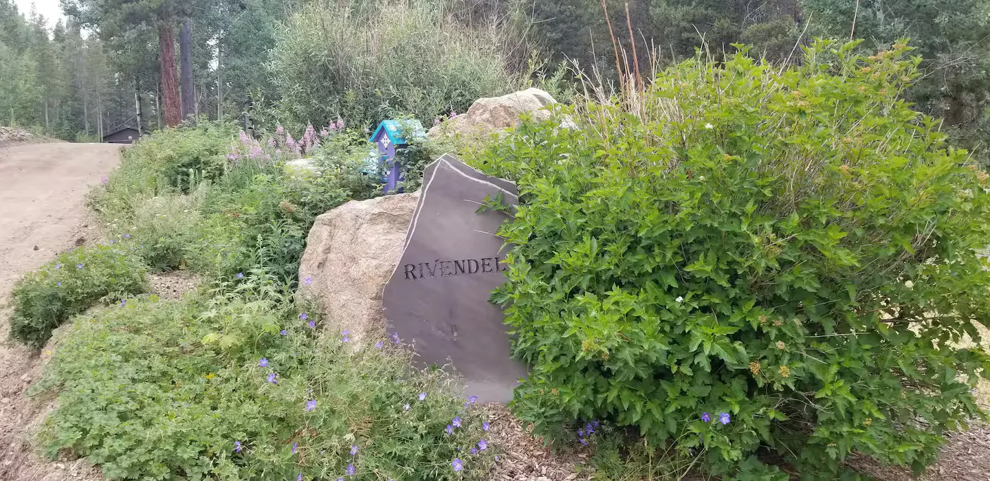 The wooden “Rivendell” sign welcoming guests at the property entrance.